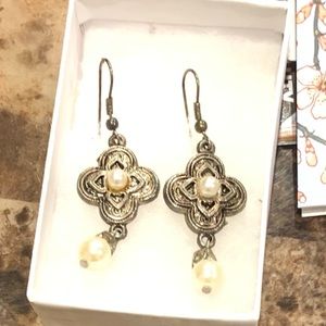 Intricate gold toned pieced dangle earrings with Pearl style accents